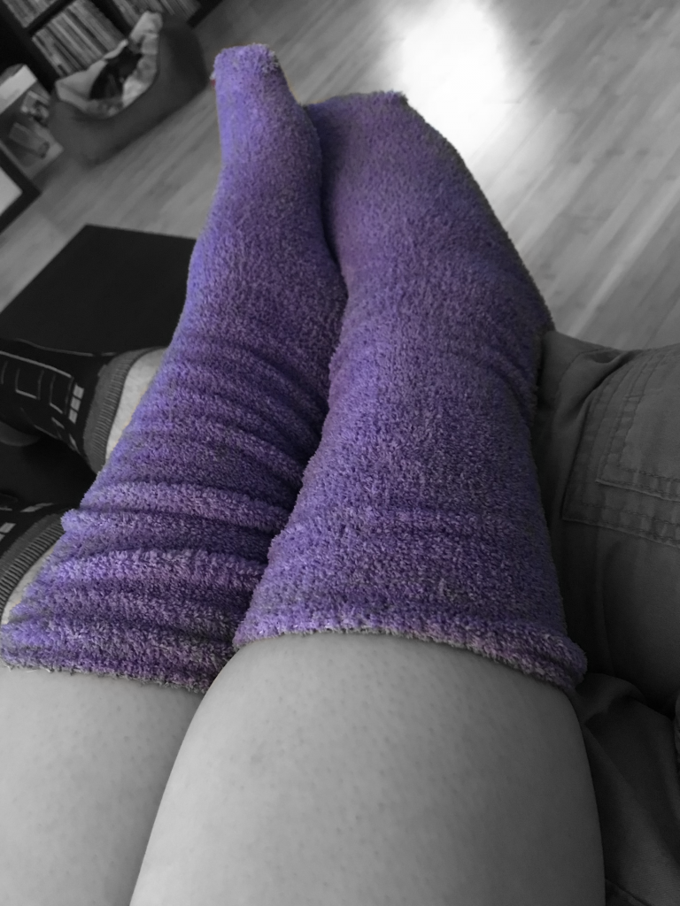 Her purple fuzzy foot warmers